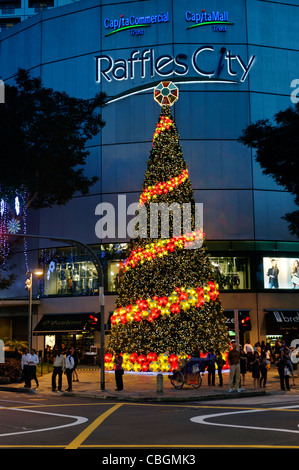 Large Christmas Tree outside Raffles City shopping mall in City Hall, Singapore. Stock Photo