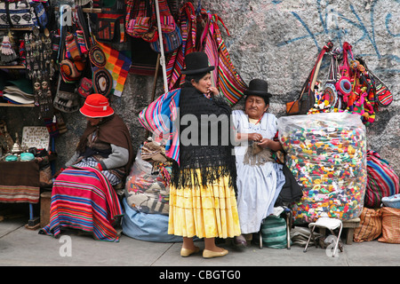 Old native women with traditional witch's at market stall with souvenirs at the witch's market in th city La Paz, Bolivia Stock Photo
