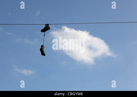 Shoefiti - sneakers, trainers dangling from overhead power lines, Greenpoint, Brooklyn, NY, USA Stock Photo