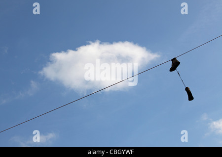 Shoefiti - trainers, sneakers dangling from overhead power lines, Greenpoint, Brooklyn, NY, USA Stock Photo
