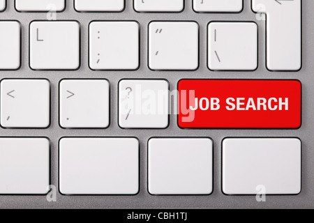 Laptop keyboard and red key "JOB SEARCH" on it. Studio shot. Stock Photo