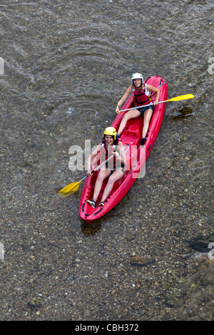 Girls adventure sports canoeing down river at Les Vignes Gorges du Tarn France Stock Photo