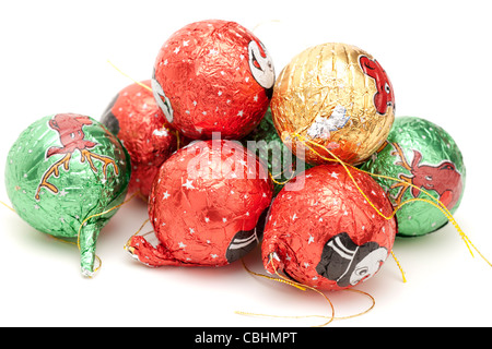 Christmas tree silver foil wrapped chocolate balls with ties on a white background Stock Photo