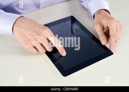 Businessman hands are touching on contemporary tablet pc. Stock Photo