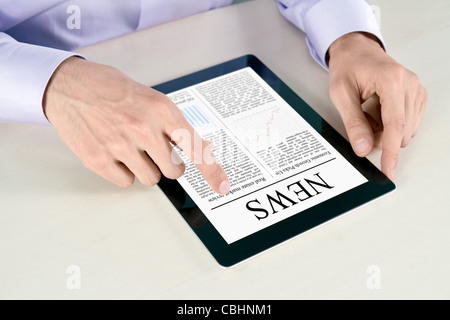 Businessman hands are pointing on contemporary tablet pc with latest news. Stock Photo
