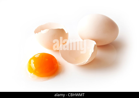 Two eggs and one yolk on white background Stock Photo