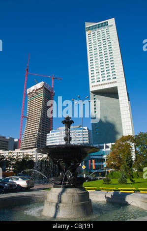 Fountain and new buildings Emilii Plater street central Warsaw Poland Europe Stock Photo