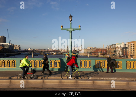 cyclists commuters using the cycle lane on southwark bridge towards the city of london england united kingdom uk Stock Photo