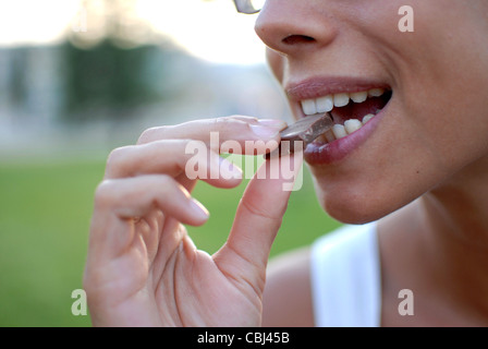 Young woman eating chocolate Stock Photo