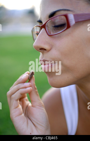 Young woman eating chocolate Stock Photo