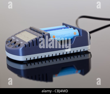 AA size NiMH battery charger with four battery cells Stock Photo