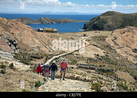 Tourists hiking on the island Isla del Sol in Lake Titicaca, Bolivia Stock Photo
