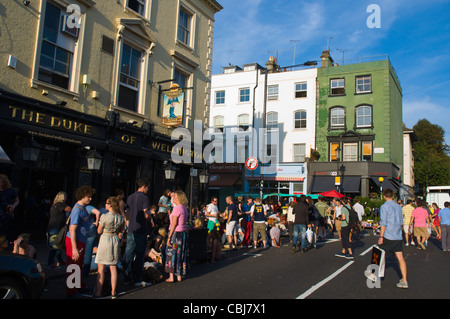 Corner of Elgin Crescent and Portobello Road streets on busy Saturday market day Notting Hill district London England UK Europe Stock Photo