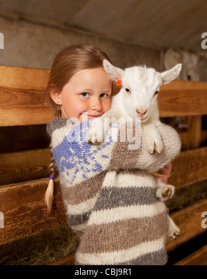 Girl holidng goat kid, Goat farm Iceland Stock Photo