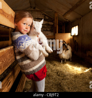 Girl holidng goat kid, Goat farm Iceland Stock Photo