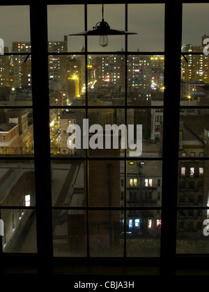 12th floor window at night overlooking NYC York City, New York, USA Stock Photo