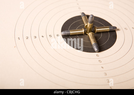 Target and several .22 caliber bullets (focus on bullets) Stock Photo