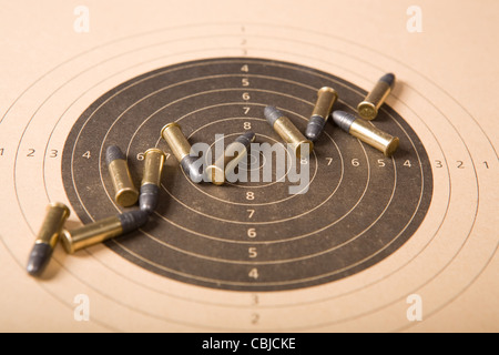 Target and several .22 caliber bullets (focus on center) Stock Photo