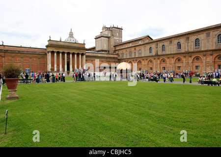 Outside in the courtyard with sphere and visitors at the Vatican Museum in Italy Stock Photo