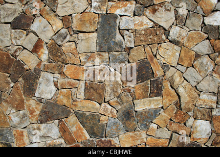 orange, gray, brown, and tan stone wall background Stock Photo