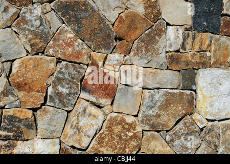 orange, gray, brown, and tan rock wall background Stock Photo