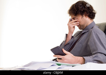 Man stressed doing paper work Stock Photo