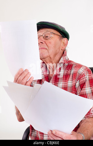 old Man calculating paper work Stock Photo