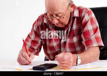 old Man calculating paper work Stock Photo