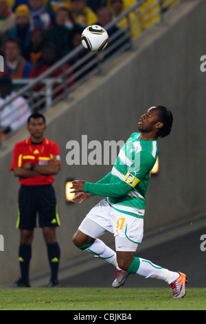 Côte d'Ivoire team captain Didier Drogba tracks the ball during a 2010 FIFA World Cup match against Brazil. Stock Photo