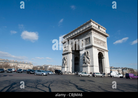 The Arc de Triomphe from the encompassing roundabout during the day time daytime featuring. Stock Photo