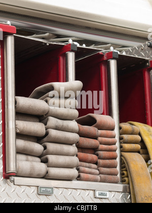 Fire hoses folded in fire truck. Stock Photo