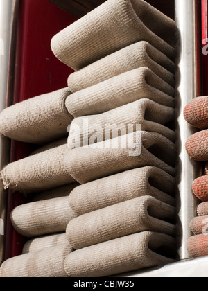 Fire hoses folded in fire truck. Stock Photo