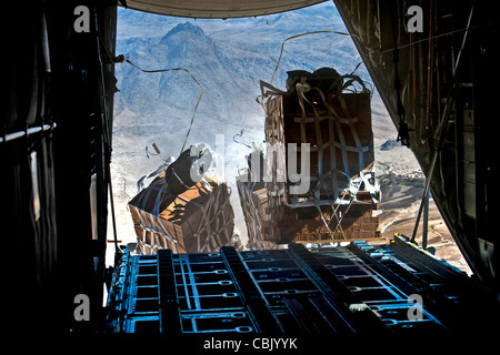 Crews drop pallets supplies from a U.S. Air Force C-130 Hercules aircraft over Bagram Airfield in Kandahar, Afghanistan Stock Photo