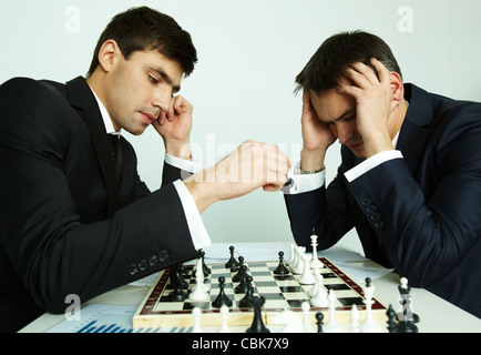 Image of businessman making move while playing chess with his rival in front of him Stock Photo