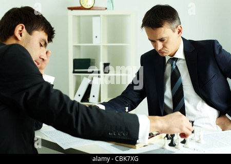 Image of two businessmen looking at chessboard while playing chess Stock Photo