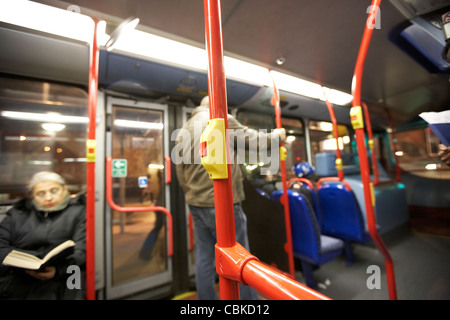 stop push button on red double deck bus at night london england uk united kingdom Stock Photo