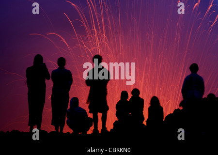 March 6, 2010 - Silhouette of tourists observing the Strombolian eruption of Yasur Volcano, Tanna Island, Vanuatu. Stock Photo