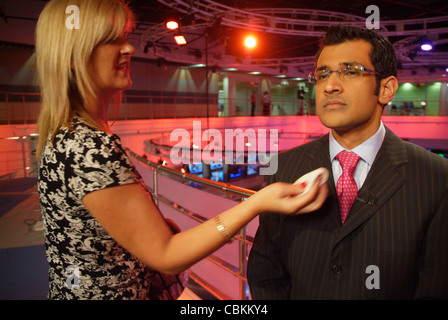 Al Jazeera English anchor delivering the news at the Doha HQ of AJE ...