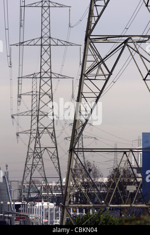 electricity pylons towering over commercial buildings in London Stock Photo