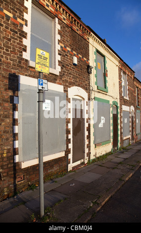 Police Notice Rows of Boarded Up houses and sealed derelict empty Terraced Property, house, terrace, architecture, home in Anfield, Liverpool, UK Stock Photo