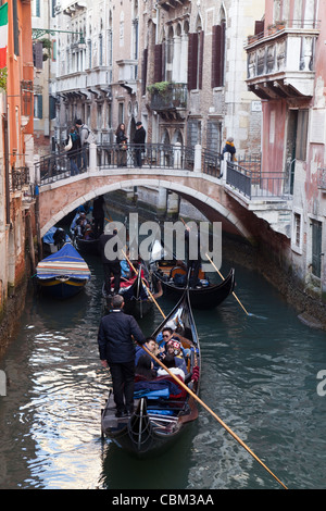Tourists ride in gondolas in Venice, Italy, December 2011. Stock Photo