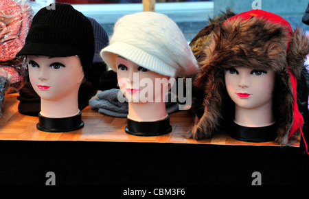 Three mannequins heads on a market stall Stock Photo