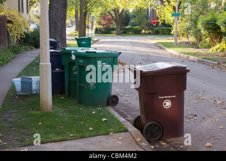 Recycling and garbage dumpsters at curbside on collection day Oak Park Illinois Stock Photo
