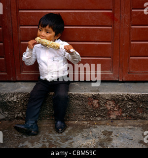 Mexico Chipas Boy Eating A Corn On The Cob Stock Photo