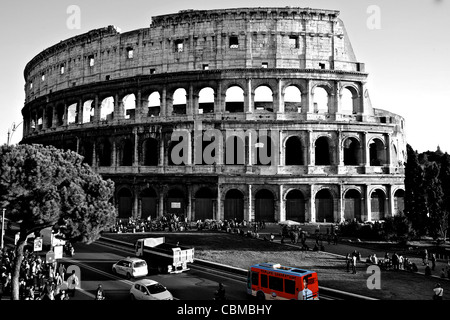 red bus in the traffic of rome passing near Colosseum in black and white Stock Photo