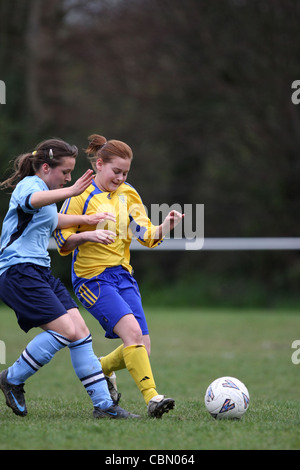 Girls playing football in a youth league match Stock Photo