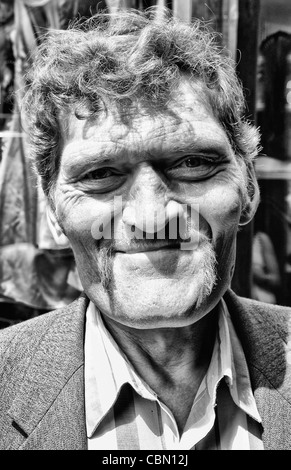 Tough looking giant man with extreme large head in city center in Lviv Ukraine Stock Photo