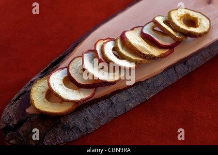 Apple chips from dried apple rings on a wooden board  Stock Photo