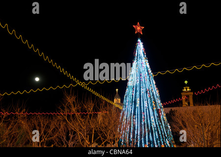 A Christmas tree is flanked by the  steeples of Bethlehem's Church of the Nativity, traditional site of the birthplace of Jesus. Stock Photo