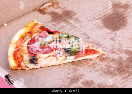 Pizza slice in paper box, closeup on white Stock Photo